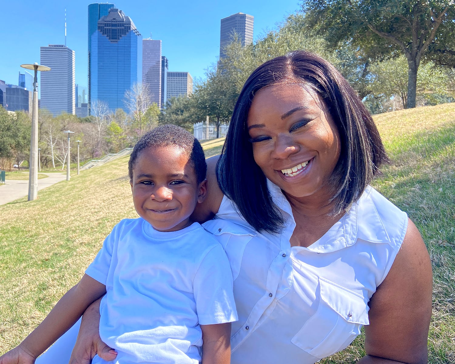 Mother and child smiling with Houston skyline in the background