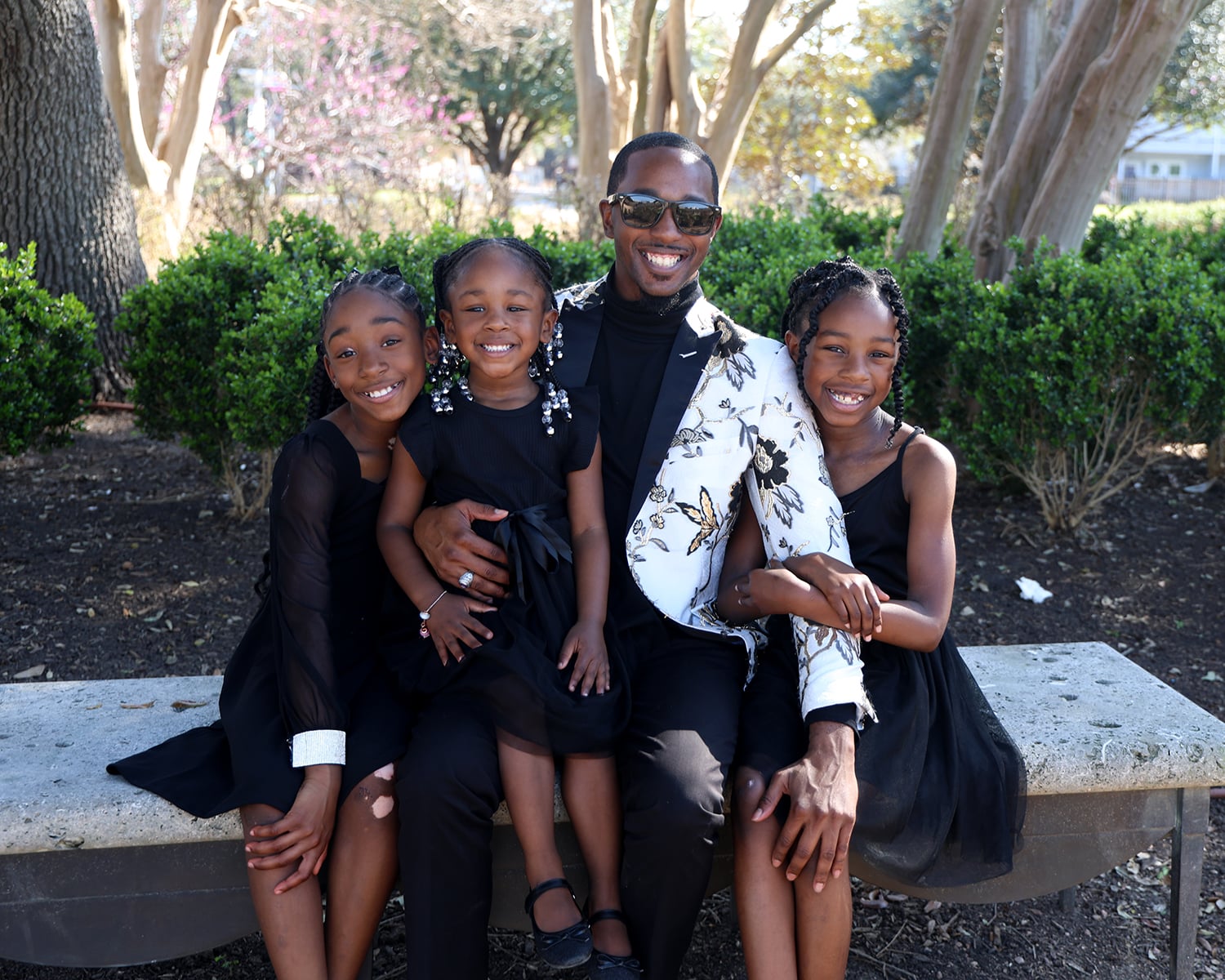 Father with three daughters outdoors